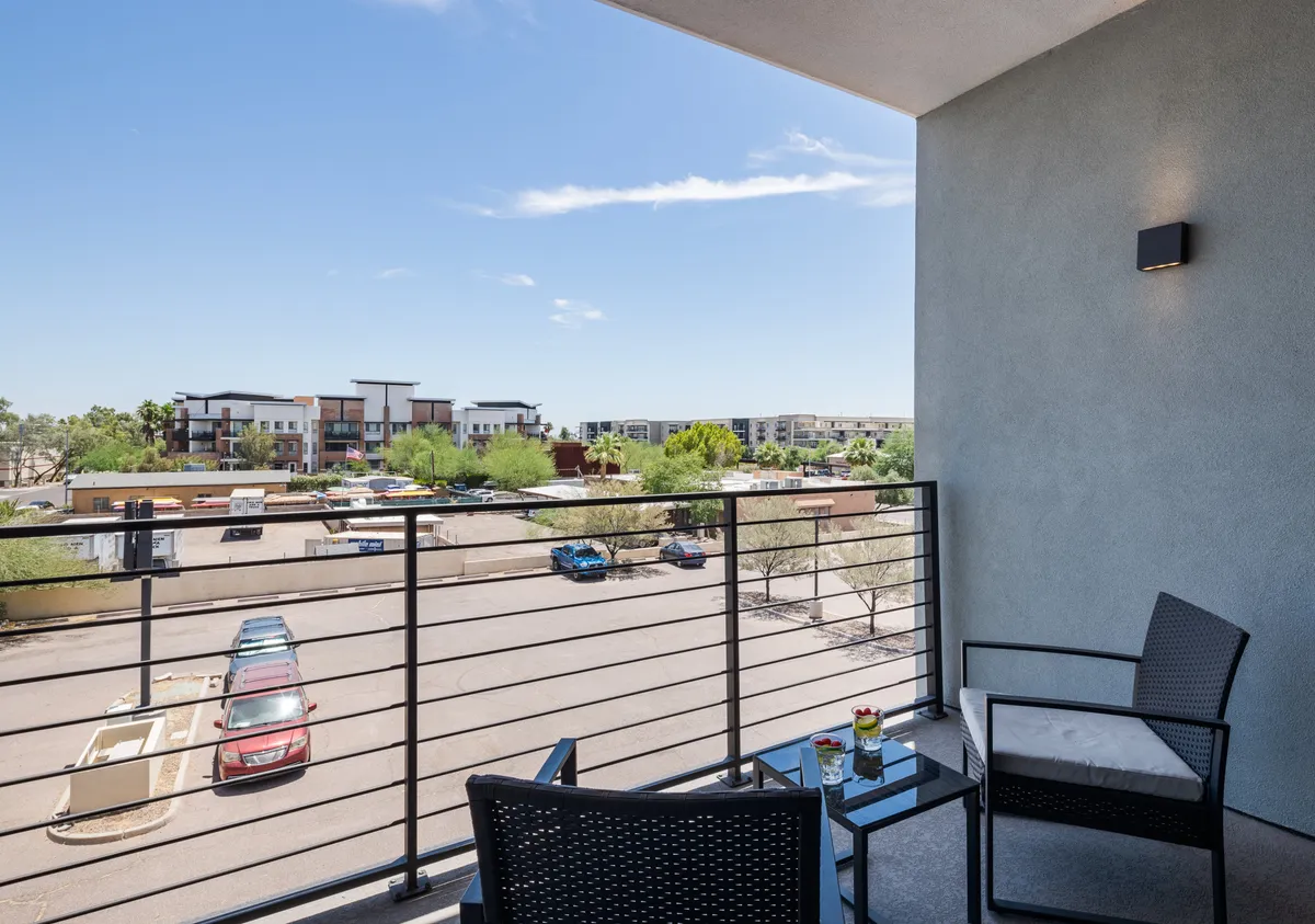 A private balcony equipped with seating and a decorative plant, offering a serene view of the surrounding area. The space is ideal for morning coffee, evening relaxation, or quiet moments alone.